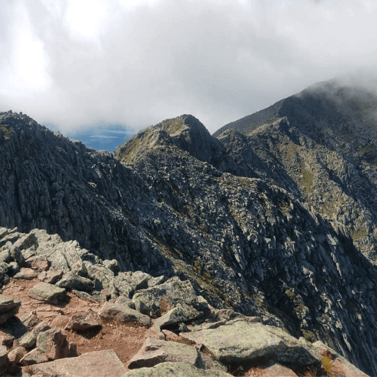 Rugged mountain terrain representing summit trails