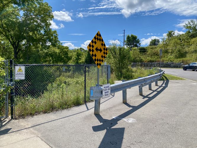 Trail continues behind guardrail
