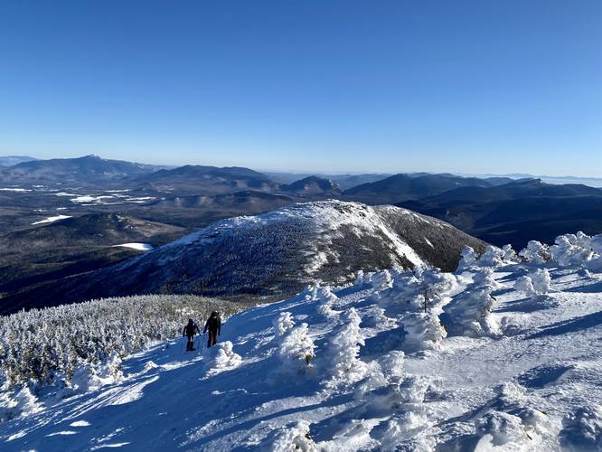 Hikers ascending Algonquin Peak with stunning views of the Adirondack Mountains