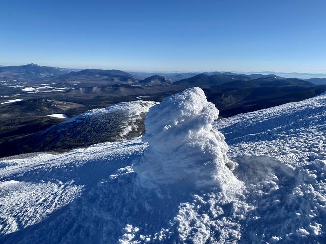 View with snow-covered rock cairn on Algonquin Peak