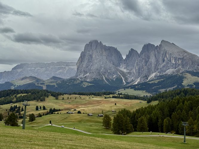 Chalets dot the landscape with dramatic alpine peaks in Seiser Alm
