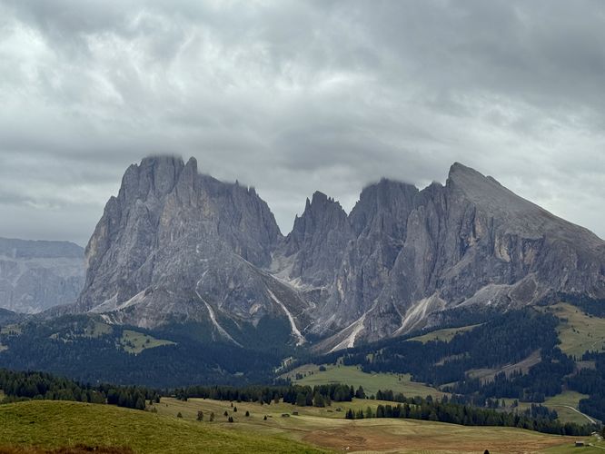 Clouds hover over the alpine peaks of the Langkofel Group massif