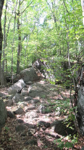 Trail cuts through a large boulder