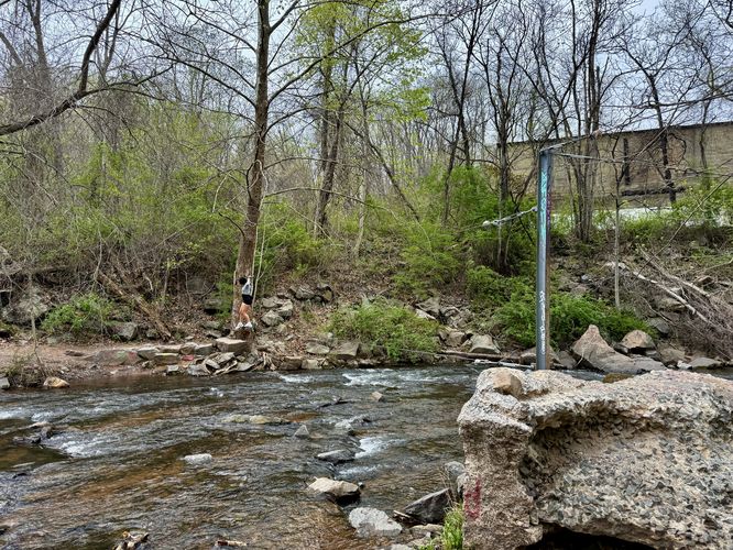 Creek crossing with metal cable. Watch your balance