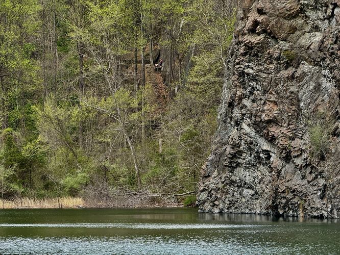View of Birdsboro Climbing Quarry cliffs and climbers in the distance