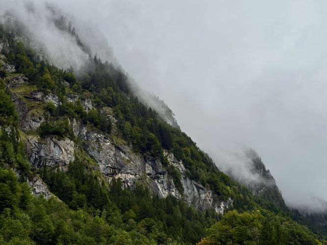 Misty mountains tower above the Kander River and Blausee
