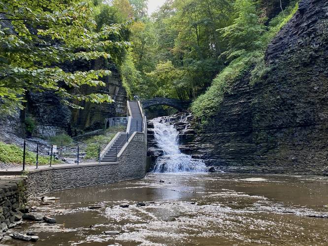 View of the waterfall and stone foot bridge
