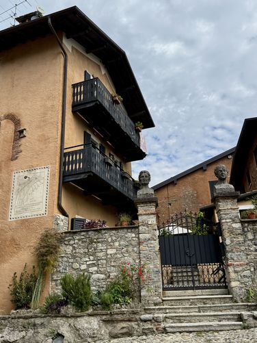 Sundial sits on a residential building. Cascata di Tobi is a right-hand turn here