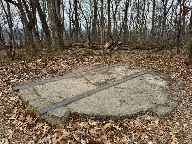 Old railroad encased in concrete, forming a platform of sorts