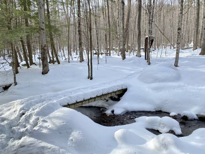 Bridge crosses snow-covered Clements Brook