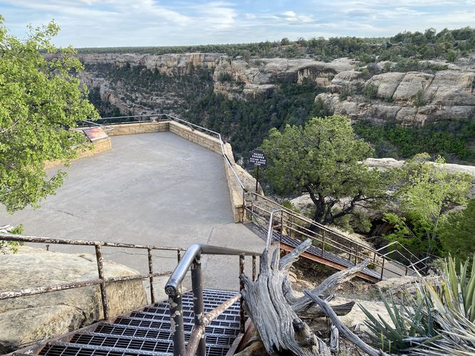 Stairs lead down to a viewing platform for the Cliff Palace