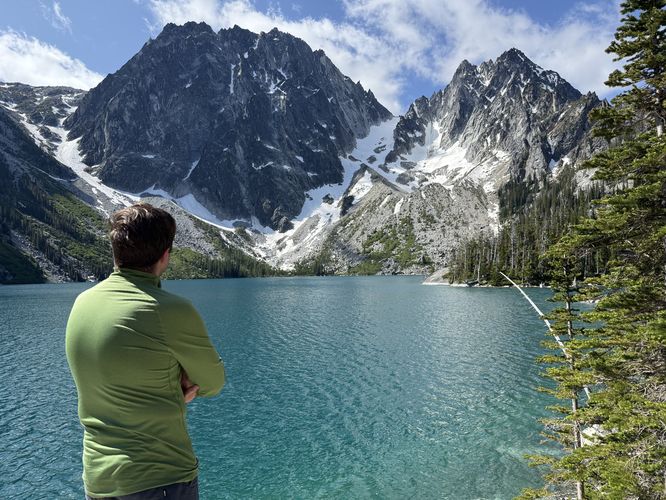 Taking in the sights of Dragontail Peak, Colchuck Peak, and the turquoise waters of Colchuck Lake