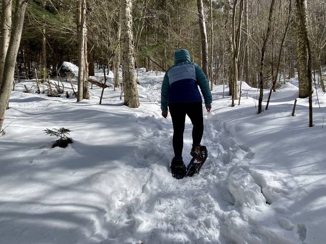 Snowshoeing up the steep hill to reach Copperas Pond