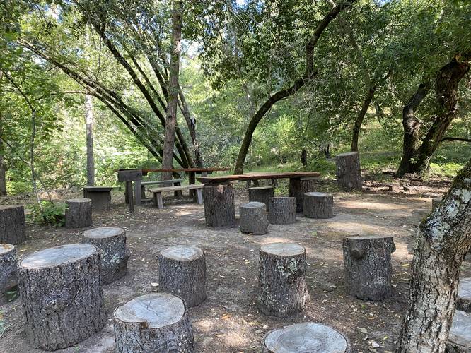 "Lost playground" / gathering site with tables, benches and stools