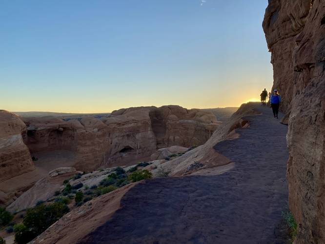 Hiking the cliff to reach Delicate Arch around sunrise