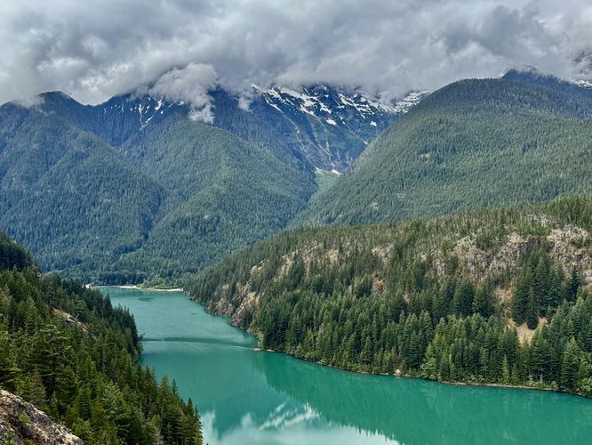 Breathtaking views of Diablo Lake's turquoise water with alpine mountains in the distance
