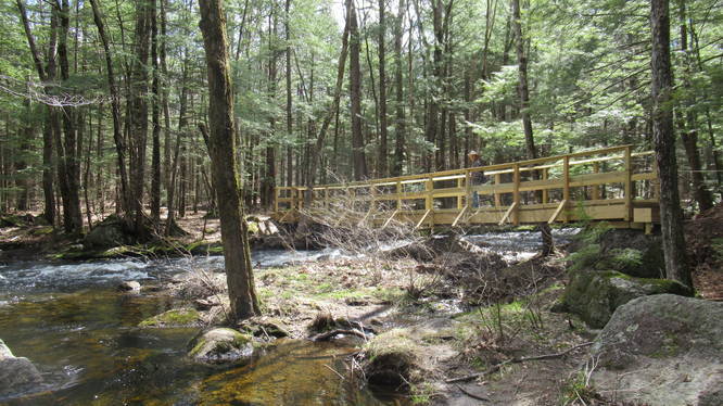 Two sections of the brook converge. A big sturdy wooden bridge provide safe passage