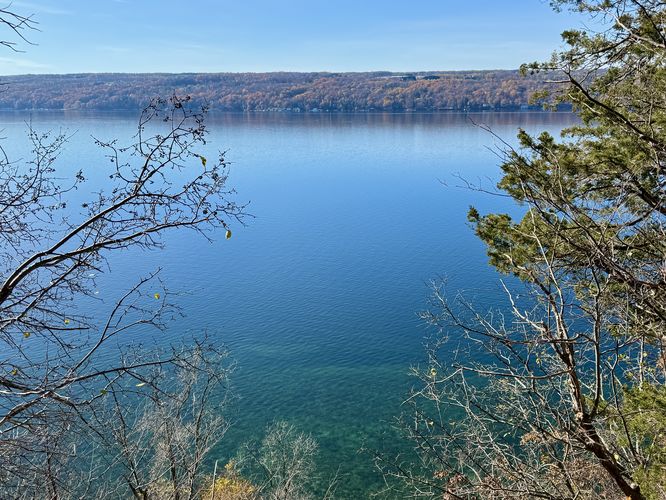View of Cayuga Lake with turquoise waters below from Edwards Lake Cliffs