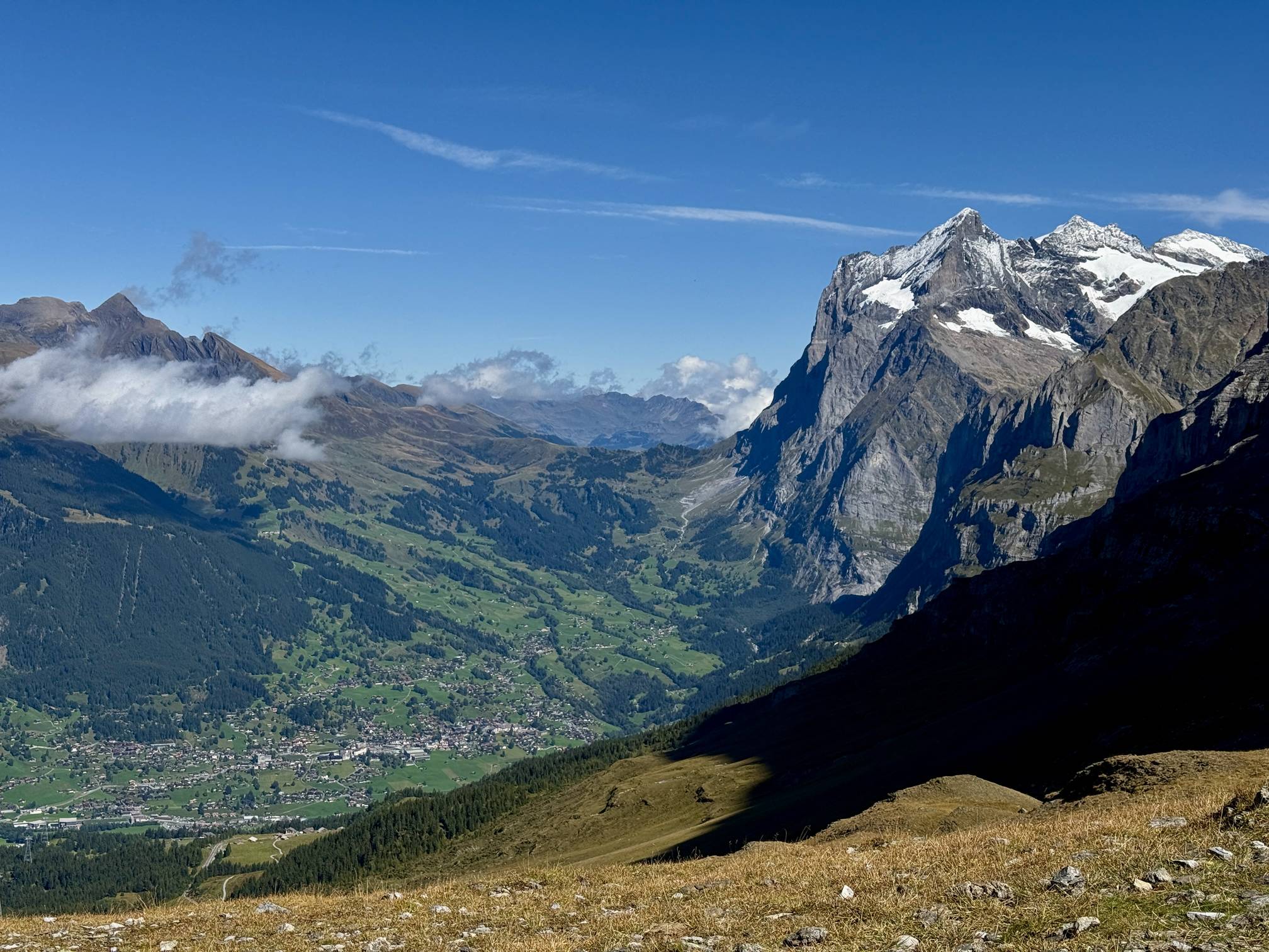 A towering alpine mountain stands over the Grindelwald valley, Switzerland.