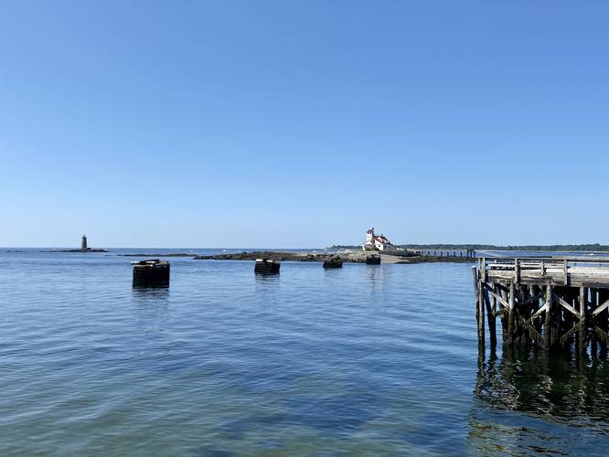View of submarine net cribs and Wood Island Lifesaving Station from the pier