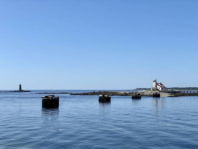 View of submarine net cribs and Wood Island Lifesaving Station from the pier