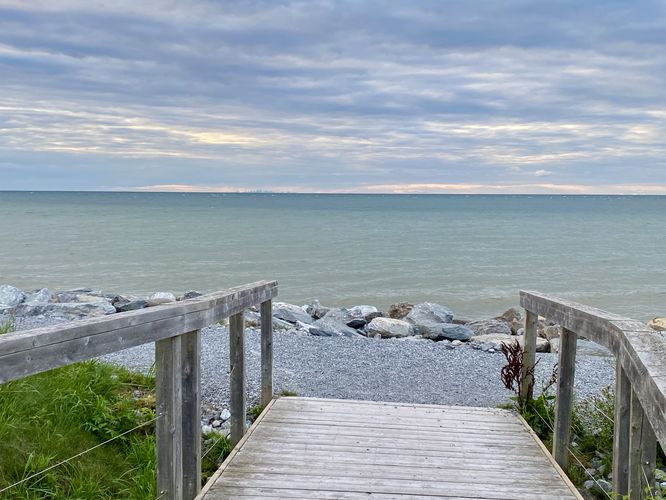 Boardwalk leads to a gravel foot path along the water