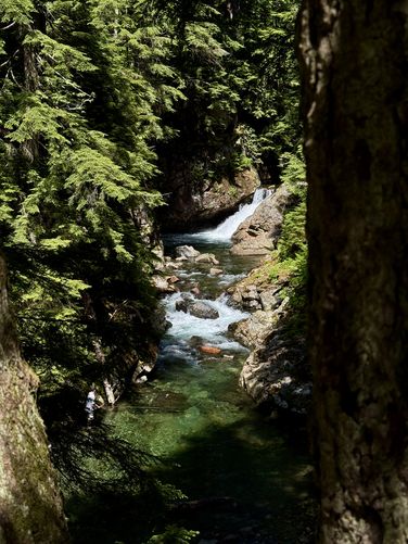 Fisherman at a turquoise pool below Denny Camp Falls