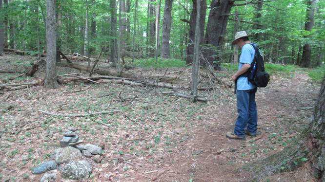 Small low Rock Cairn markes the juction in the trail to the pond