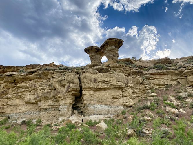Mushroom rocks stand in the nearby cliff
