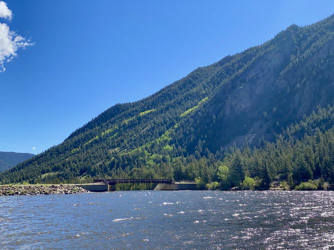 View of Georgetown Lake, its surrounding mountains, and the footbridge across the spillway