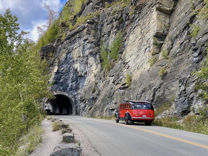 Tour bus drives toward the West Tunnel on Going-to-the-Sun Road