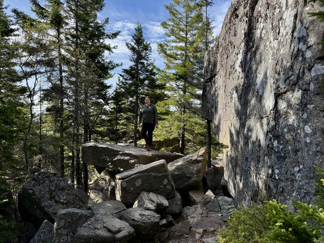 Trail traverses large boulders below the Cadillac Cliffs