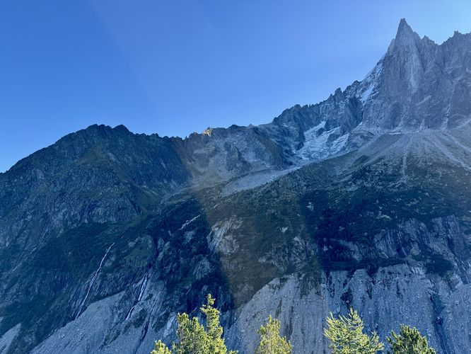 View of massive waterfalls cascading down from Glacier du Nant Blanc and Aiguille Verte