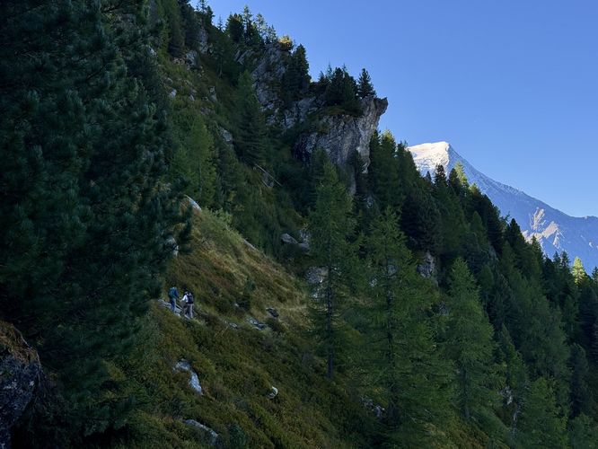 Hikers traverse the Mont Blanc massif on their way toward Plan de l'Aiguille