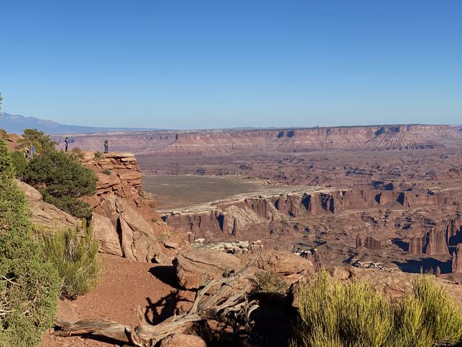 Hikers stand at the cliff's edge along th Grand View Point Trail in Canyonlands National Park