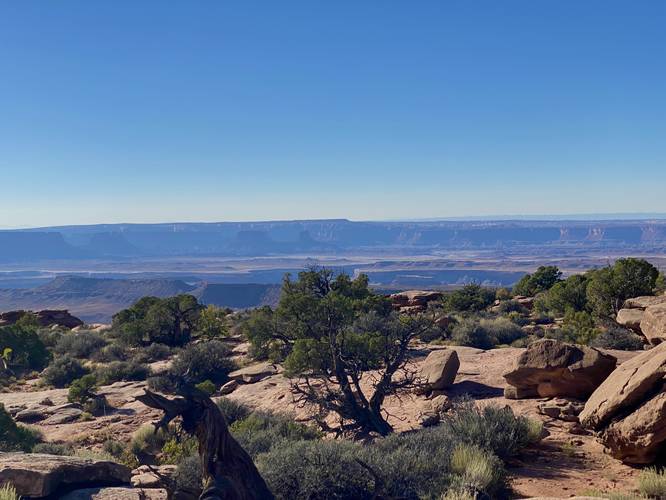 Westward view includes mesas. cliffs, and canyons