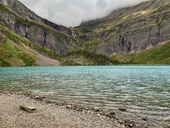 Turquoise waters of Grinnell Lake and view of 960-foot tall Grinnell Falls
