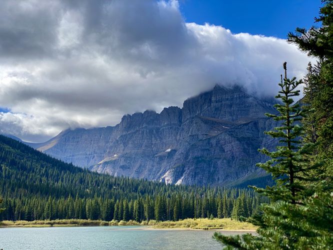 Mount Gould with clouds covering the summit towers over Josephine Lake
