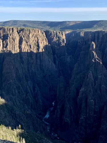 Shadows drown out the Black Canyon in the early morning daylight - Gunnison Point Overlook