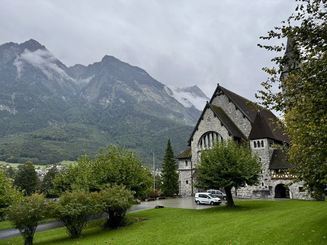 Pfarrkirche St. Nikolaus with a backdrop of the Alps in Liechtenstein