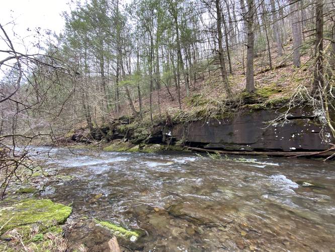 Cedar Run creek with large rocky cliffs across the way - hike south