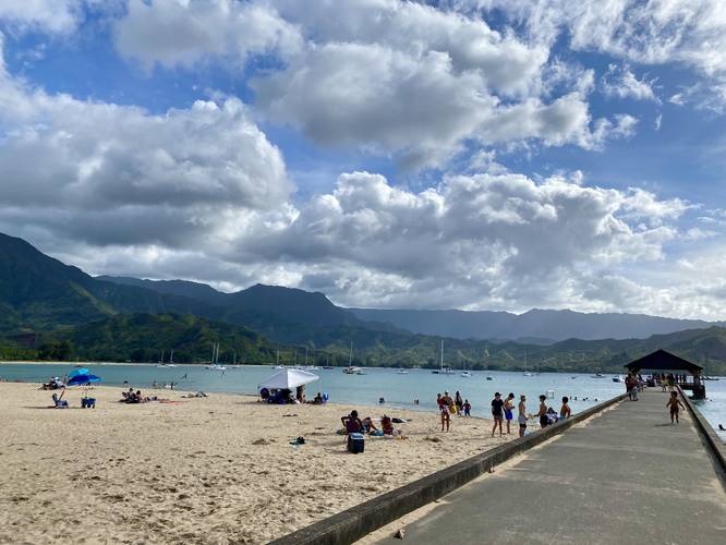 View of Hanalei Pier and Hanalei Bay with surrounding mountains
