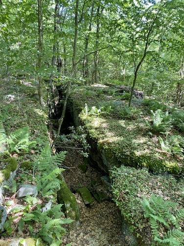 Hiking over rock crevasse along Mid State Trail