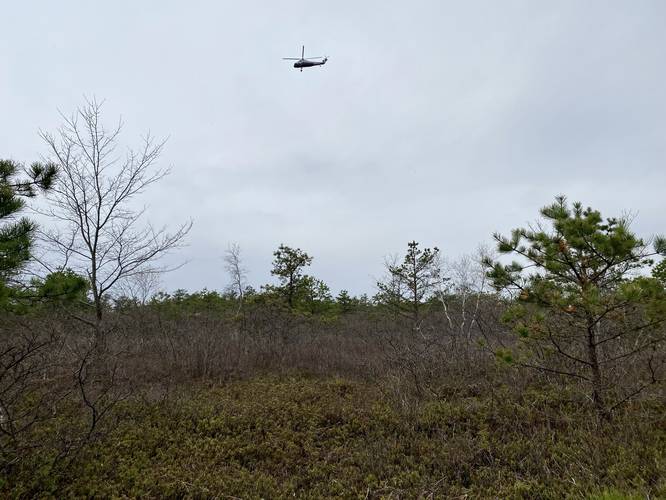 Helicopter flying over heath barrens