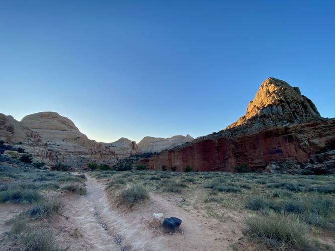 Sunrise casts light upon the rock cliffs and reefs at Capitol Reef National Park