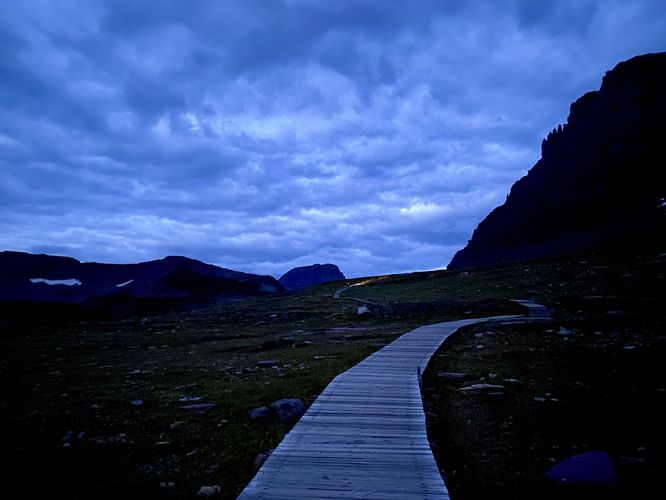 Hikers in the distance with boardwalk of the trail