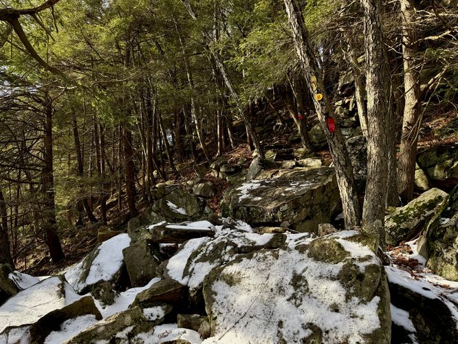 Slippery snow covers the boulders in the trail