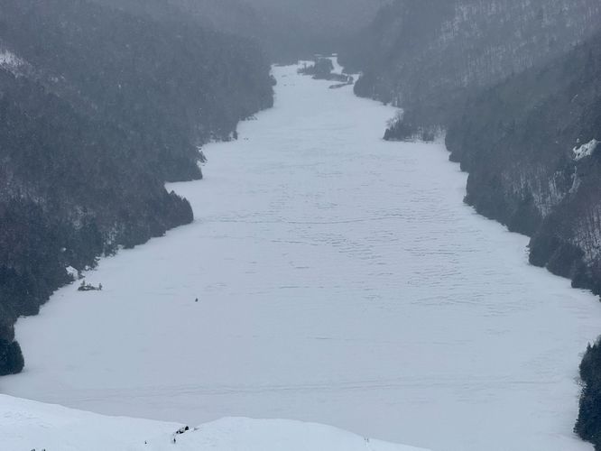 Snowmobiler driving across Lower Ausable Lake