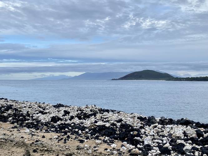 View of Pu'u Olai cinder cone, West Maui Mountains, island of Molokai (right)