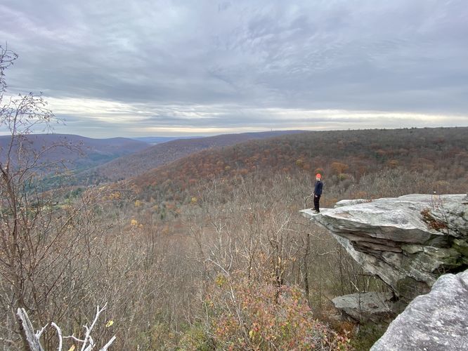 Sam Monks stands on the north cliffs of Kellogg Mountain's Overlook